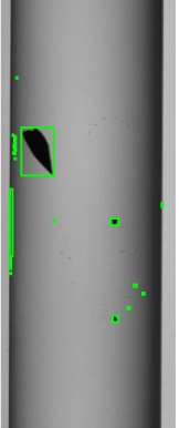 Example from the experimental dataset. A cartridge is contaminated by inner particles. Blobs detected by the segmentation algorithm are overlaid showing both correct and false detections.